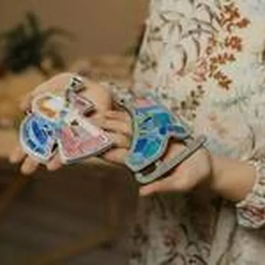 Женщина держит сувенирные магниты в руках на фоне уютной обстановки