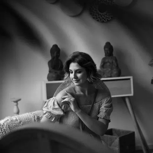 Молодая женщина в уютной комнате с статуэтками Будды, современный интерьер и спокойная атмосфера