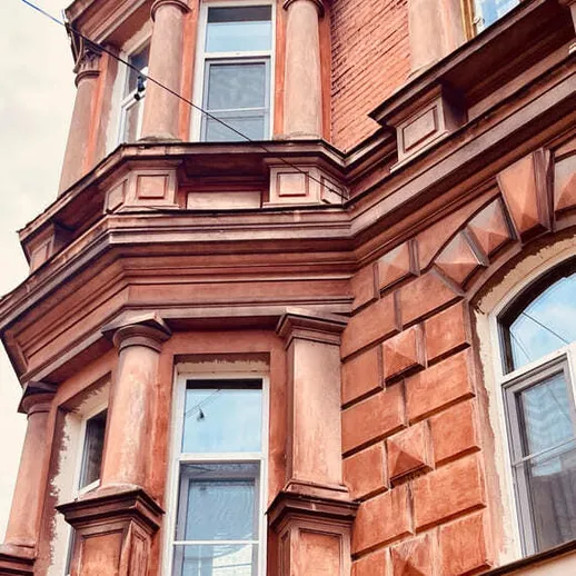 Угловой дом с колоннами в историческом центре города в ясный день