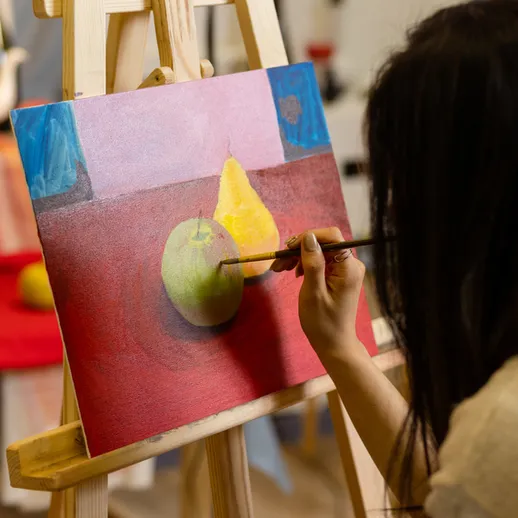 Художник создает акварельную живопись с фруктами в студии