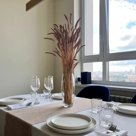 Уютный стол для ужина с красивым оформлением и видом на город в солнечный день