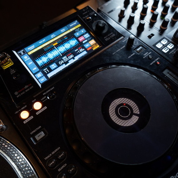 Настольный DJ-оборудование с экраном и пластинкой, использованное во время вечеринки в клубе. Фото 11