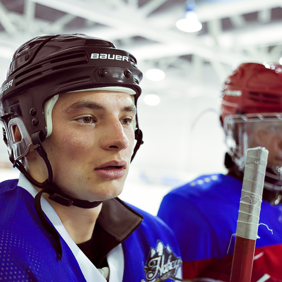 Молодые хоккеисты на тренировке в ледовом дворце, готовящиеся к игре на катке в осенний день