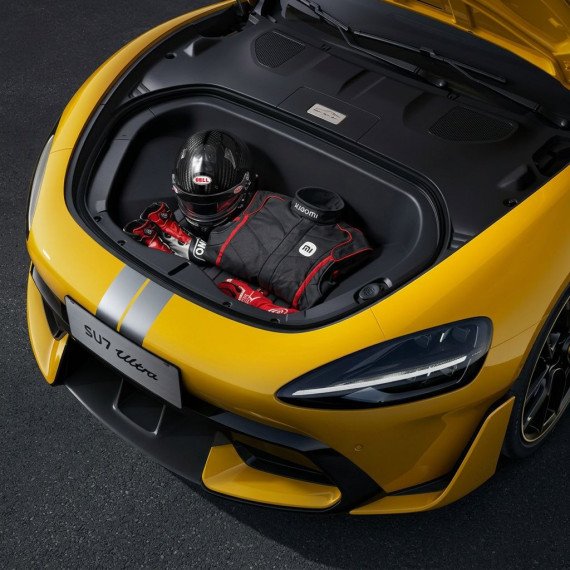 Картер автомобиля с шлемом и гоночной экипировкой в желтом спортивном автомобиле