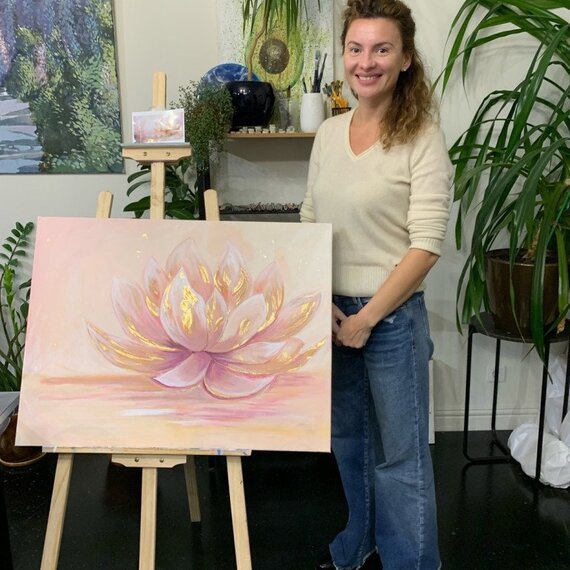 художница создает картину с лотосом в студии