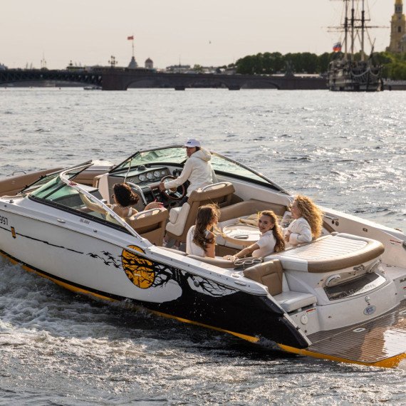 Лодка с людьми плывет по реке в центре города в ясный день. Главное фото