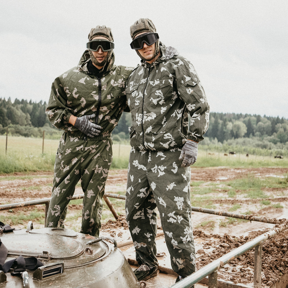 Два военнослужащих в камуфляжной форме на танке во время учений на фоне леса и грязных дорожек. Фото 29