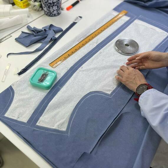 Процесс раскроя ткани в atelier для создания одежды в мастерской шитья. Фото 10