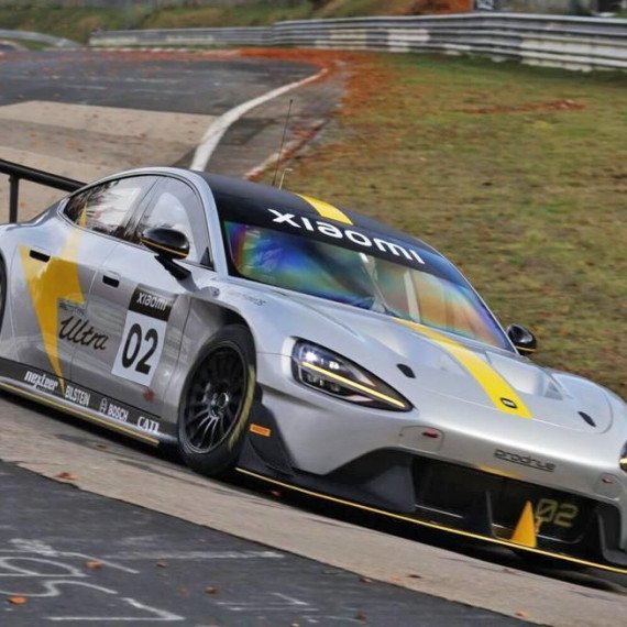 Машина проезжает трассу на соревнованиях в Нюрбургринге с логотипом Xiaomi