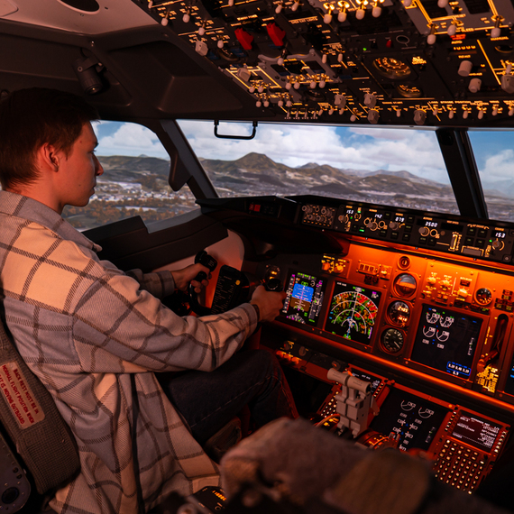 Пилот управляет симулятором Boeing, погружённый в процесс обучения в тренажёрном центре Пилот управляет симулятором Boeing, погружённый в процесс обучения в тренажёрном центре